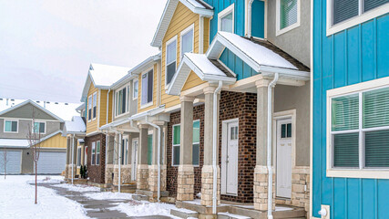 Pano Facade of apartments houses with roofs at the front entrances with white doors