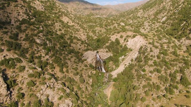 Suvtushar waterfalls Amidst Forested Mountains In Ugam-​Chatkal National Park, Uzbekistan. - Aerial Drone Shot