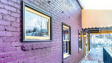 Fototapeta premium Pano Building exterior with awning over the snowy wooden deck at the entrance