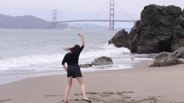 Woman Draws a Line in the Sand, Metaphorically and Literally, Dancing on the Beach