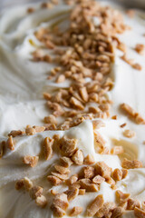 Fototapeta na wymiar Vanilla ice cream with peanuts, close up