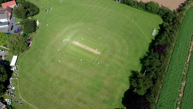High altitude 4K drone footage of an English village cricket match.