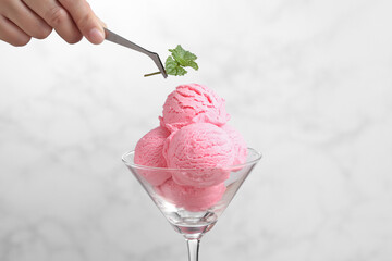 Food stylist use tweezers decorating fake icecream