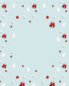 New Year frame with holiday decorations, red and white balls, knitted cap, white wooden christmas tree on blue