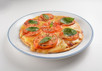 baked cheesy pizza with vegetarian margherita and tomato in white background western halal menu