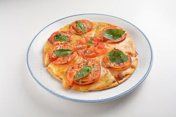 baked cheesy pizza with vegetarian margherita and tomato in white background western halal menu