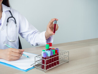 laboratory holding blood tube in hand with white copy-scape background, researching vaccine for cure virus or illness. healthcare medical-care concept.