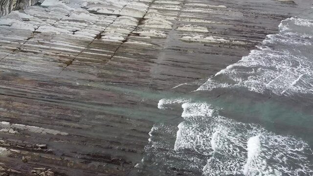 Aerial drone view of the coast flysch structure in the beach of Sakoneta in the Basque Country