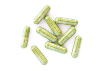 green herbal powder medicine capsule pill isolated on white 
