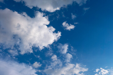 Soft white clouds against blue sky background..