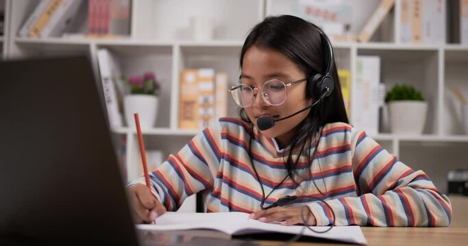 Girl glasses with headphone learning online online at home