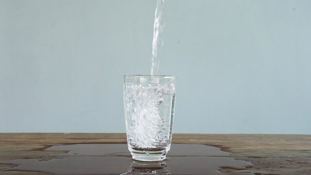 slow motion of pouring water into glass. Full HD