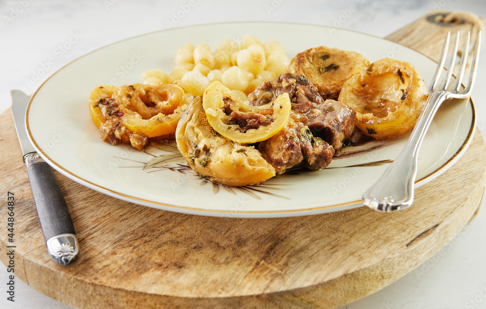 Poster Lamb with lemon, artichokes and coriander stalks fried over low heat