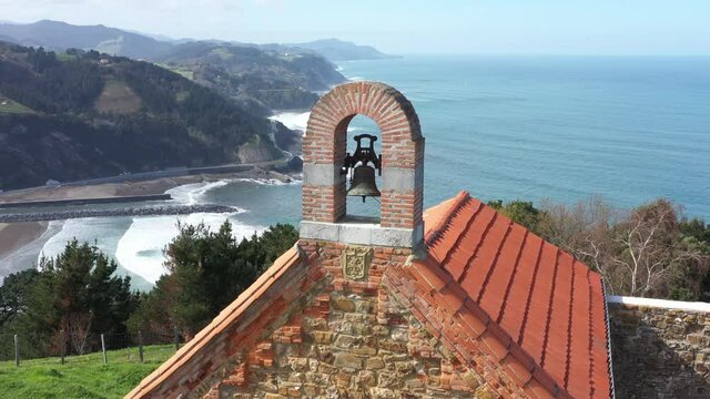 Aerial drone view of a hermitage next to the Cantabrian Sea in Deba in the Basque Country