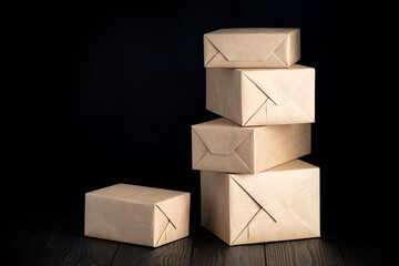 parcels or gifts wrapped in wrapping paper on black background
