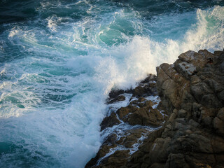 Waves breaking onto rocks. Garden Route. Western Cape. South Africa