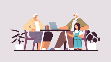 grandparents with granddaughter using laptop social media network online communication concept