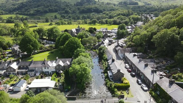 Beddgelert village in Snowdonia Wales UK Aerial footage 4K. row of terraced houses and bridge