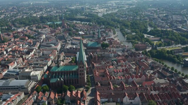 Tilt down shot of St. Marys Church and surrounding old town houses. Aerial view of landmarks in UNESCO world heritage site. Luebeck, Schleswig-Holstein, Germany