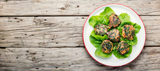 Healthy herb vegetarian cutlets,wooden background