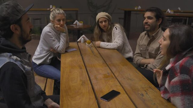 Discussing topics gossip with amigos friends at the bar