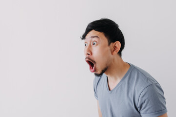 Shocked and surprised face of Asian man in isolated on white background. - obrazy, fototapety, plakaty