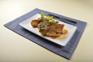 pan fried bbq fresh cod, salmon, grouper fish fillet in chef sauce with potato, corn and vegetables western halal menu