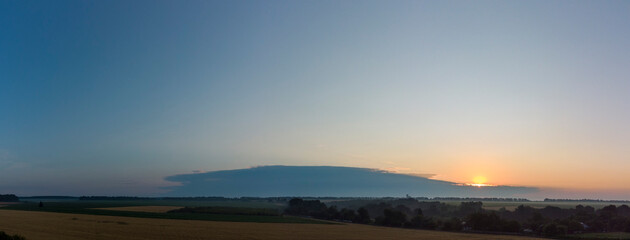 Fototapeta na wymiar Sunrise behind a storm cloud