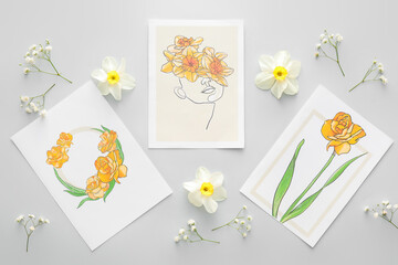 Beautiful greeting cards and flowers on grey background