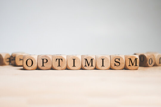 Optimism word cube on white background