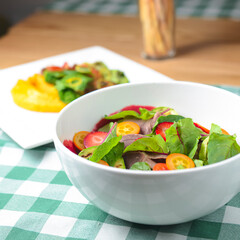 Salad with beef and strawberries in a white bowl. Meat and vegetables salad for lunch or dinner, healthy eating.