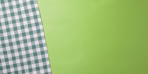 Kitchen view from above, green background. Green plaid tablecloth and free copy space for text.