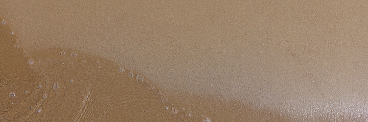 Wet sand in surf zone of the sea