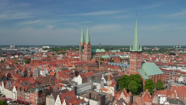 Backwards reveal of medieval old town centre. Brick buildings and tall church towers. Luebeck, Schleswig-Holstein, Germany