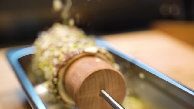 sweet dough tube. dessert is prepared on the shelves in the cafe. the bun is sprinkled with nutty sprinkles