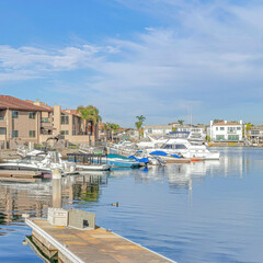 Fototapeta na wymiar Square Beautiful harbour views with boats and docks in Huntington Beach California