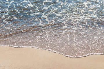 Soft wave of the sea on the sandy beach.Soft focus,blurred image.
