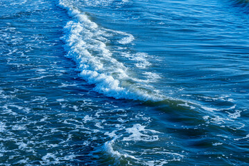 Deep blue and rough sea with lot of sea spray.Blue background.Soft focus,blurred image.