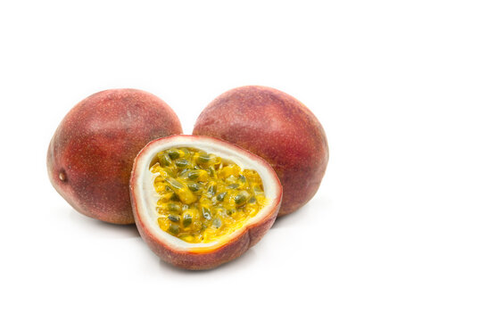 Passion fruit in group display, one sliced passion fruit is put together with two whole fruit, image one white background, close up to see details.