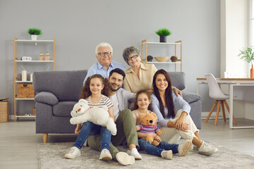 Portrait of a big family spending time together at home. Elderly grandparents, young parents and...