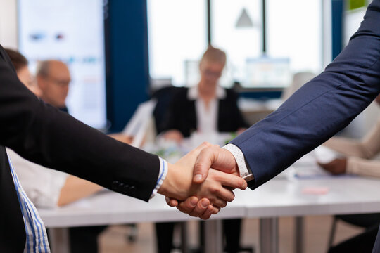 Satisfied businessman company employer wearing suit handshake in conference room , workplace. Man hr manager employ successful candidate shake hand at business meeting, placement concept