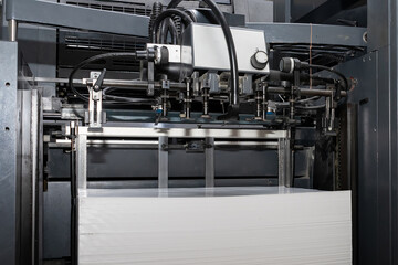A stack of paper is loaded into a typewriter