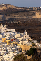 Fototapeta premium The whitewashed town of Fira in warm rays of sunset on Santorini island, Cyclades, Greece