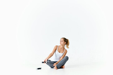 sportive woman sitting on floor with dumbbells workout muscles