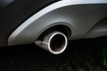 The exhausting pipe of a black car.