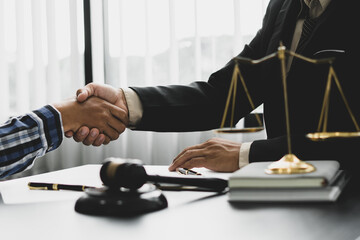 Businessman shaking hands to seal a deal with his partner lawyers or attorneys discussing a contract agreement.Legal law, advice, and justice concept.