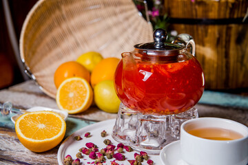 berry sea buckthorn tea in a glass teapot in a cafe