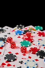Casino chips, playing cards and dices on dark reflective background