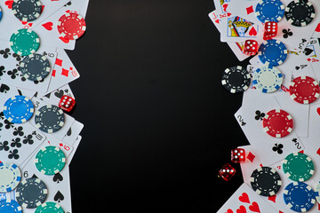 Casino chips, playing cards and dices on dark reflective background