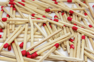 texture of scattered matches with red heads on white background